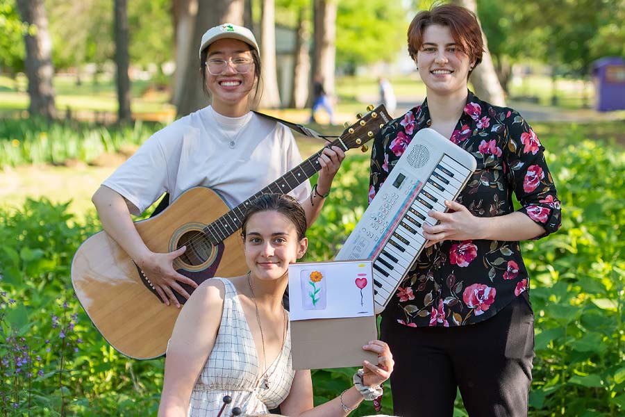 Three musicians play in the butterfly garden