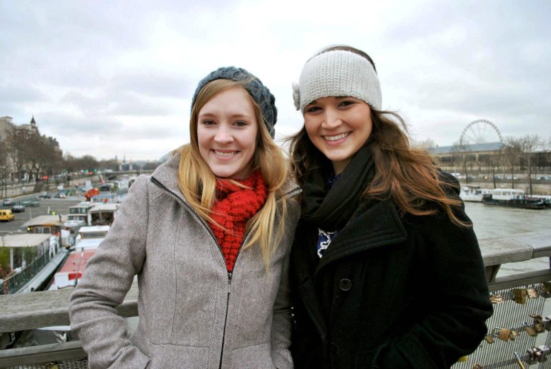 Two TWU students smile in winter clothes in Paris, France.