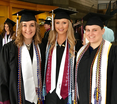 3 Psi Chi graduates with stoles and honor cords