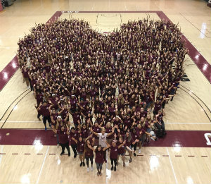 Photo of students and Chancellor in a heart formation. 