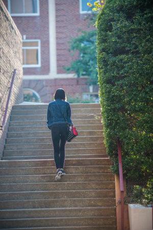 A student walking up stairs on TWU's Denton Campus.
