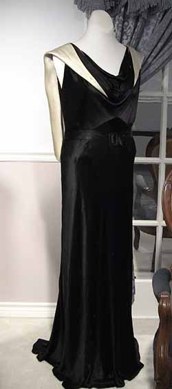 Black satin dress with a black satin scarf over the shoulders.