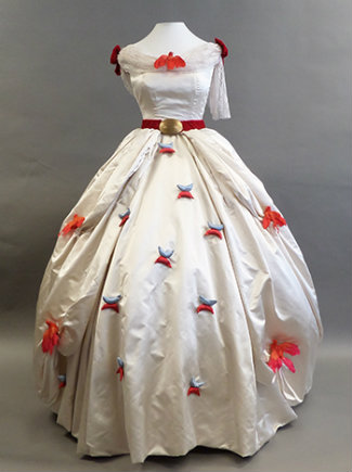 Lubbock's white satin dress with scattered red flowers on the skirt and a red velvet belt.