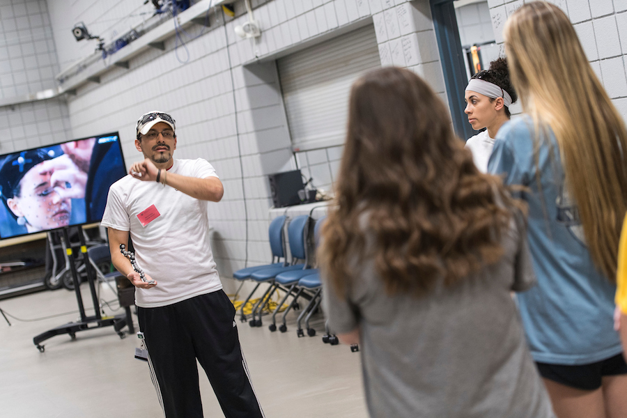 TWU PhD student talks with three high schoolers about motion capture technology