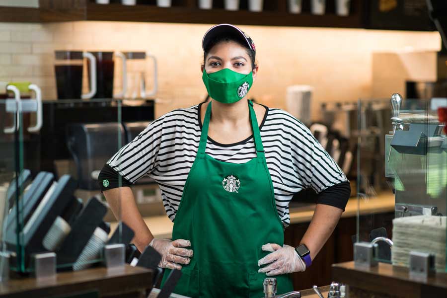 A TWU Starbucks student employee wears a mask while at work at the Denton campus Starbucks.