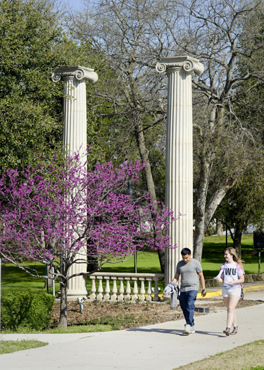 Students walking next to TWU columns