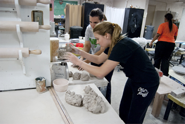 2 students working in a ceramics facility