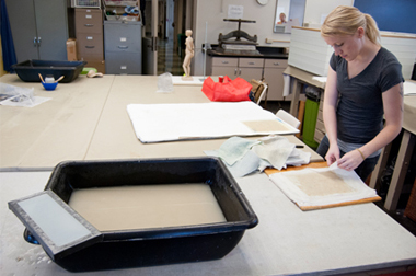 A TWU student working on a papermaking project in our studio.